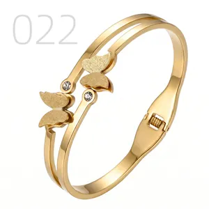 Detail of gold butterfly bangle with spring hinge and sparkling crystal accents