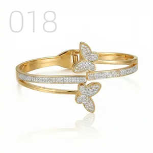Detail of gold butterfly bangle with pave-set zircon stones and spring hinge closure