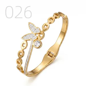 Detail of gold butterfly bracelet showing cubic zirconia inlay and hollow chain structure