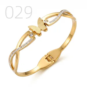 Detailed macro of gold butterfly bangle featuring frosted wings and sparkling crystals