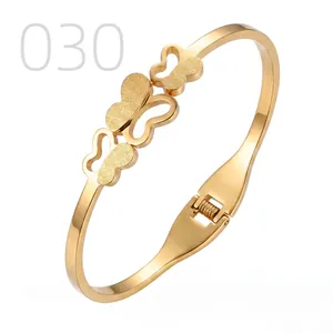 Detail of golden stainless steel butterfly bracelet featuring matte and polished textures