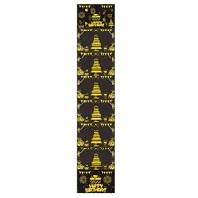 Close-up of black and gold Happy Birthday table runner with cake and firework patterns