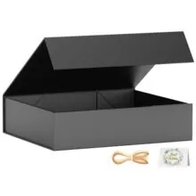 Detail of premium black magnetic gift box with golden ribbon bow and best wishes card