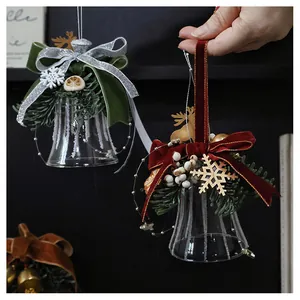 Macro detail of Christmas glass bells with velvet bows and frost pine needle decor