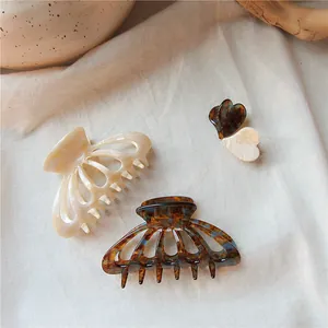 Detail view of premium acetate hair clips featuring marble and tortoiseshell patterns