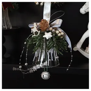 Detailed shot of a Christmas glass bell with pine cones, white berries, and a wooden horse
