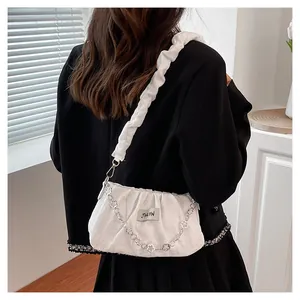 Detail of white pleated shoulder bag with floral silver chain and scrunchie strap