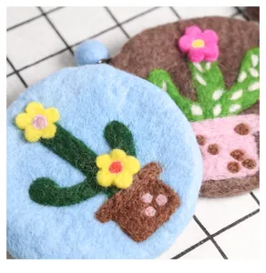 Macro shot showing fuzzy wool felt cactus coin purses with delicate floral embroidery