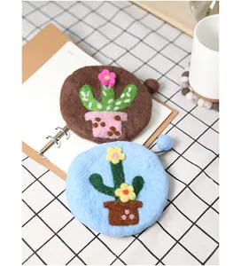 Detail of handmade wool felt cactus coin purses with delicate floral embroidery work