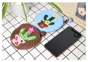 Detail of handmade wool felt cactus coin purse with zipper and soft pompom charm
