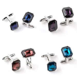 Detail of silver round cufflinks with emerald-cut crystals in multiple colors