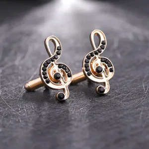 Macro shot of rose gold treble clef cufflinks with inlaid black crystals for men