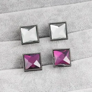 Macro detail of square cut rhinestones in purple and clear with gunmetal frames