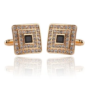 Macro detail of square gold cufflinks with crystal pavé and black center stone for shirts