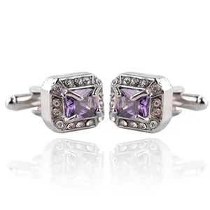 Close-up of square purple crystal cufflinks with a halo of white stones and silver base