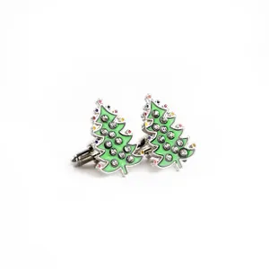 Detailed close-up of Christmas tree cufflinks with green enamel and sparkling rhinestones