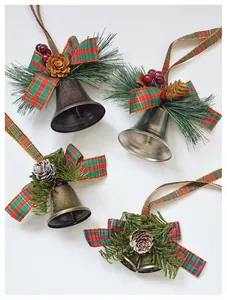 Close-up of four Christmas bell ornaments with pine cones and red plaid ribbons