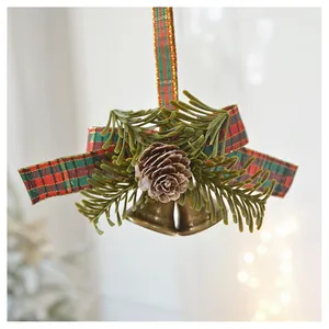 Close-up of Christmas bells with pine cones, needles and tartan ribbon decorations