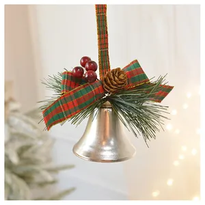 Close-up of Christmas bell with red velvet bow, pine needles and natural pine cone decoration