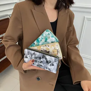 Detailed view of women long PU wallets with watercolor prints and gold zippers