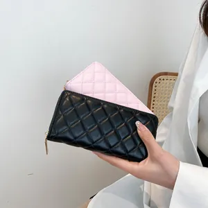 Close-up of diamond-quilted faux leather women's wallets in black and pink colors