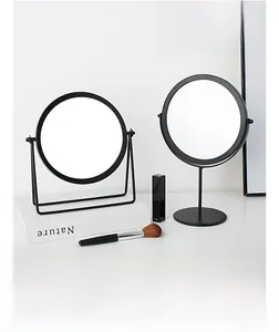 Detail showing 360-degree adjustable desktop mirror with matte black metal frame finish
