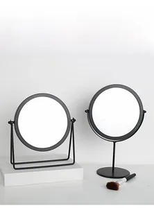 Detail of modern black desktop makeup mirrors with metal stand and base designs