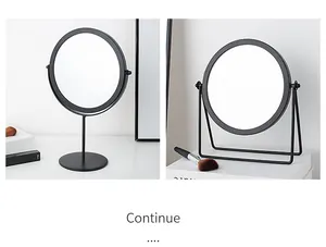 Macro detail of two minimalist round desktop makeup mirrors with matte black metal frames