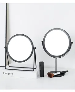 Detail of round desktop makeup mirrors with matte black metal frames and sleek stands