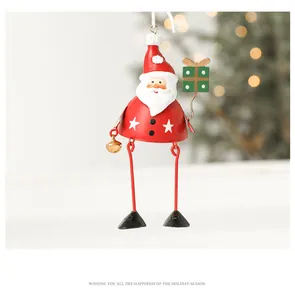 Close-up of Santa Claus metal ornament with golden bell on a festive Christmas tree