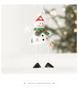 Detail of metal snowman ornament with red hat and golden bell for Christmas decor