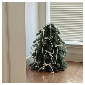 Mini Christmas tree with white bows and warm LED lights for tabletop festive decoration