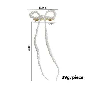 Dimensions détaillées de la pince à cheveux nœud en perles avec pompon, 10,5 cm