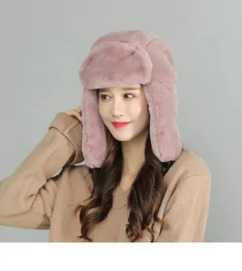 Detail of pink faux fur trapper hat with ear flaps and secure buckle for winter warmth
