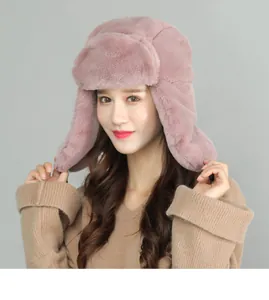 Detail shot of the thick plush lining and soft faux fur on the pink winter trapper hat
