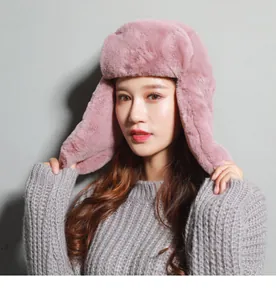 Close-up of pink faux fur trapper hat showing soft texture and earflap detail