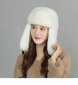 Detailed view of plush white faux fur winter trapper hat with thick ear flaps