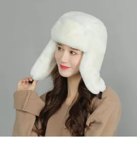 Detailed close-up of a white faux fur ushanka winter hat with earflaps and buckle