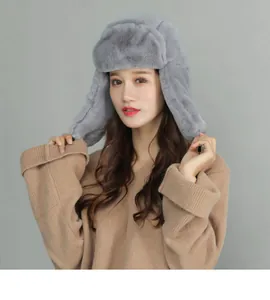 Close-up of thick grey plush faux fur and warm ear flaps on the winter trapper hat