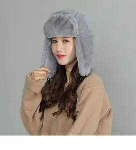 Detail of grey faux fur trapper hat featuring plush texture and adjustable chin buckle