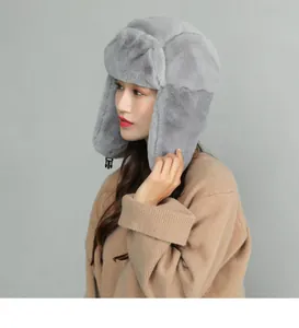 Close-up of gray plush trapper hat featuring soft faux fur and chin strap buckle