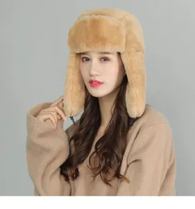 Close-up of thick plush earmuffs and warm faux fur texture on the brown trapper hat