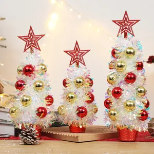 Three sizes of white tinsel Christmas trees with red and gold baubles and star toppers
