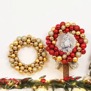 Detail of festive Christmas wreaths with red and gold ornaments and LED lighting