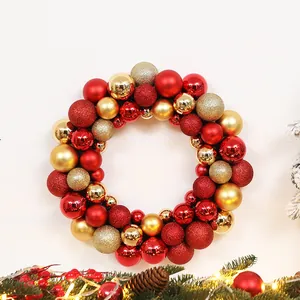 Detail showing a Christmas wreath with red and gold matte, shiny, and glitter ornaments