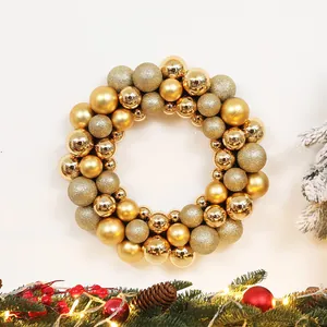Detailed view of golden Christmas wreath featuring glossy, matte, and glitter ball ornaments