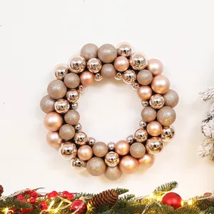 Detail of rose gold Christmas ball wreath with matte and glitter baubles on pine branches