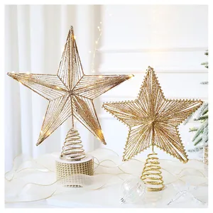 Detail of golden glitter star tree topper with LED lights and spiral spring base