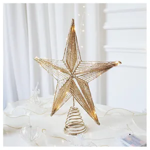 Close-up of champagne gold star tree topper with glitter wire and integrated LED lights
