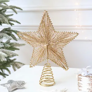 Macro detail of champagne gold glitter star tree topper with stable spiral base